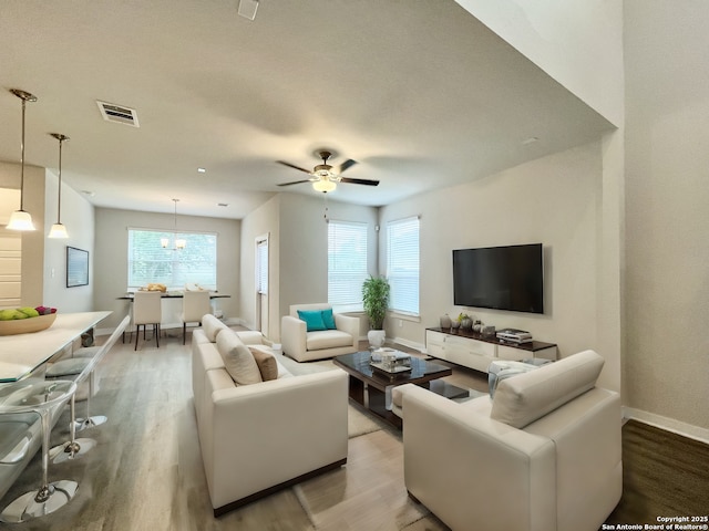 living room with hardwood / wood-style floors and ceiling fan