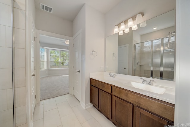 bathroom featuring walk in shower, tile patterned floors, vanity, and ceiling fan