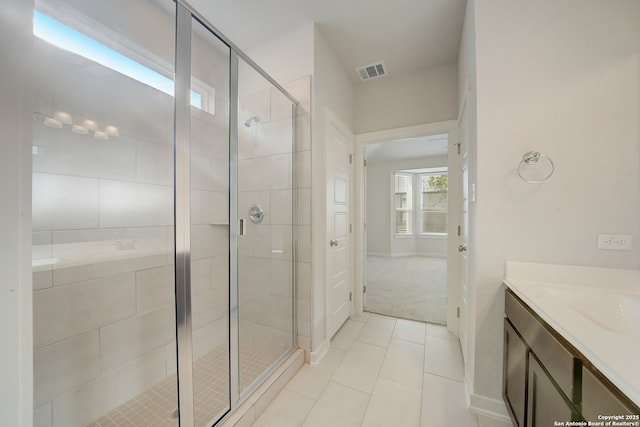 bathroom featuring vanity, an enclosed shower, and tile patterned floors