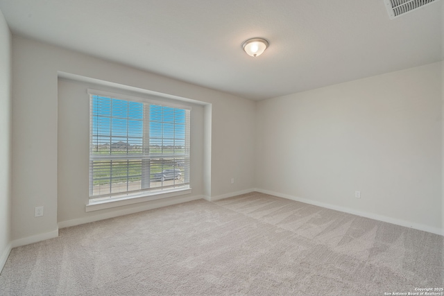 unfurnished room with light carpet