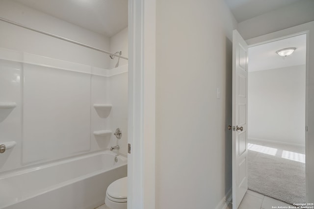 bathroom featuring tile patterned flooring, shower / tub combination, and toilet