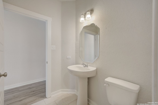 bathroom featuring tile patterned flooring and toilet