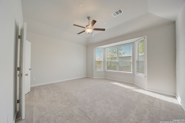 carpeted empty room with ceiling fan and vaulted ceiling