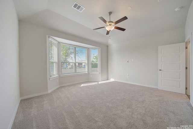 carpeted empty room with ceiling fan and vaulted ceiling