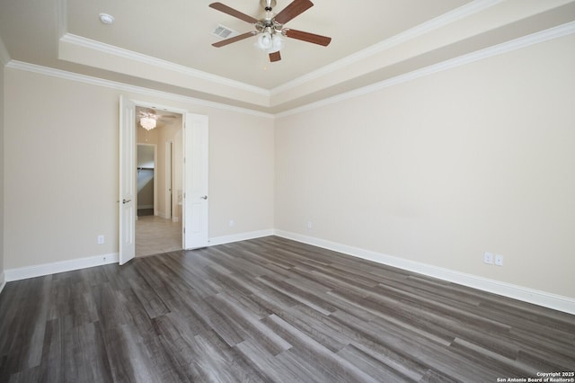 empty room with crown molding, ceiling fan, dark hardwood / wood-style flooring, and a tray ceiling