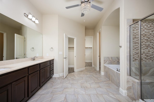 bathroom featuring vanity, ceiling fan, and separate shower and tub