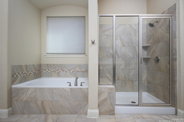 bathroom with separate shower and tub