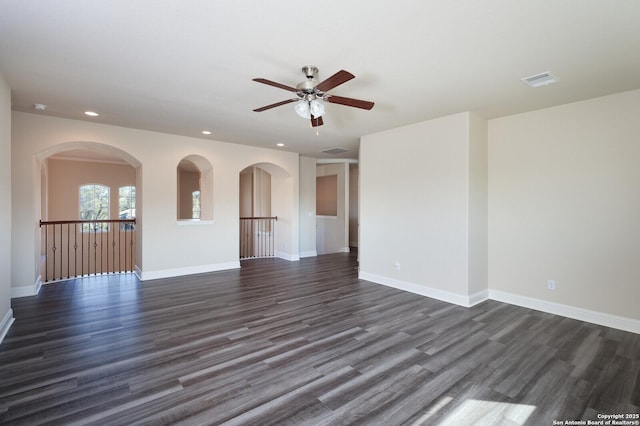 unfurnished room with dark wood-type flooring and ceiling fan