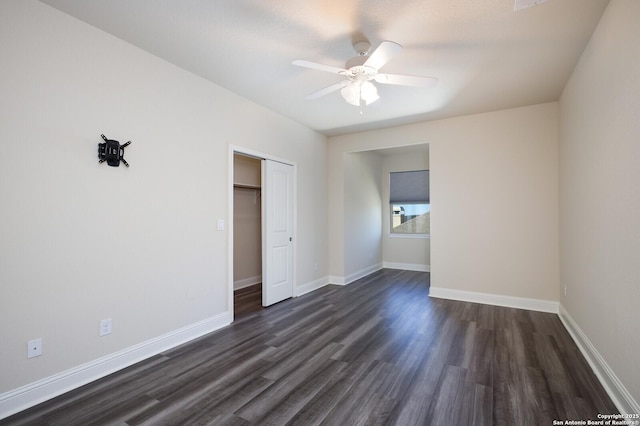 unfurnished bedroom featuring dark wood-type flooring, ceiling fan, and a closet