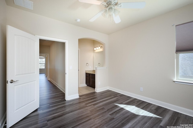 empty room featuring ceiling fan and dark hardwood / wood-style flooring