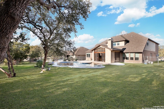 rear view of house with a yard and a patio