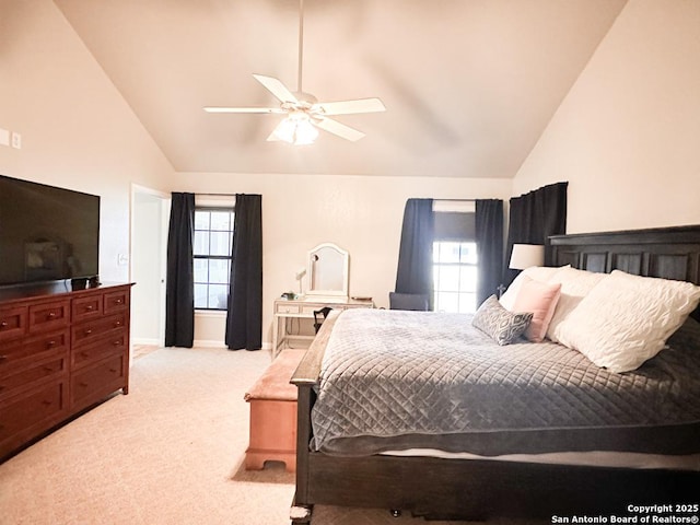 bedroom with vaulted ceiling, light colored carpet, and ceiling fan