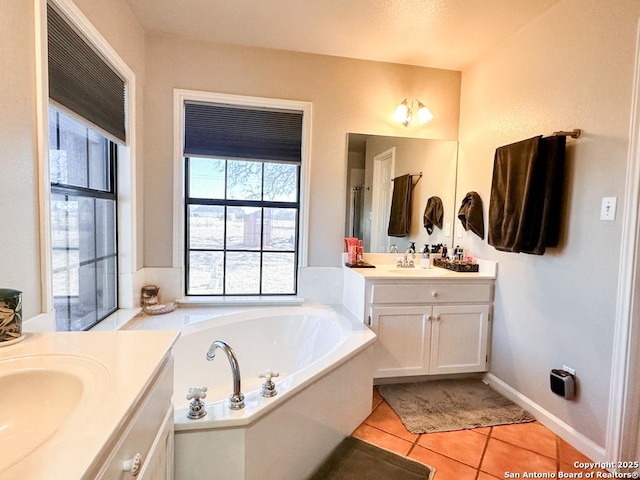 bathroom with vanity, tile patterned flooring, and a tub