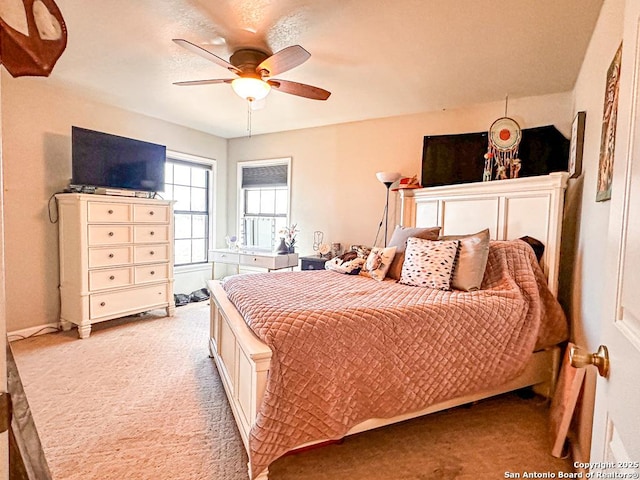 carpeted bedroom with ceiling fan