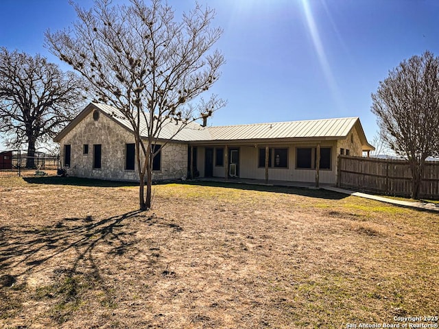 back of property with a yard