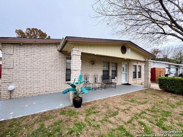 back of property with a patio