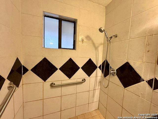 bathroom with a tile shower