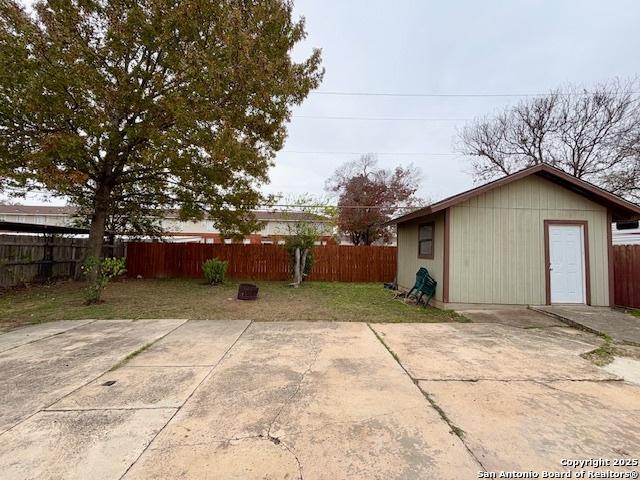 view of yard with an outbuilding and a patio area