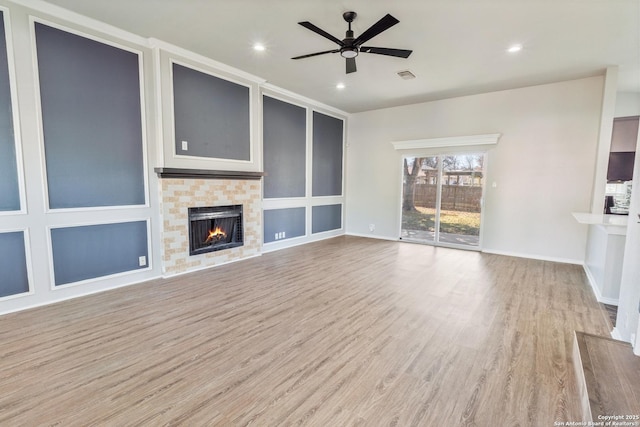 unfurnished living room with ceiling fan and light hardwood / wood-style flooring