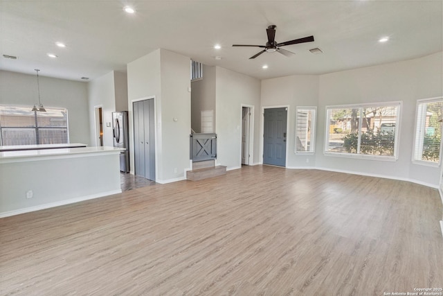 unfurnished living room featuring ceiling fan and light hardwood / wood-style flooring