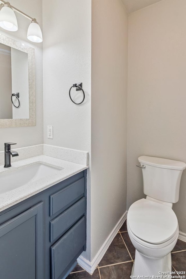 bathroom with vanity, toilet, and tile patterned flooring