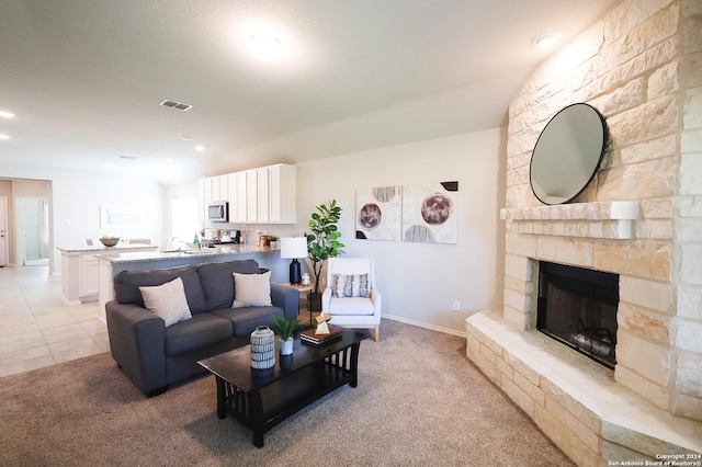 tiled living room featuring a fireplace