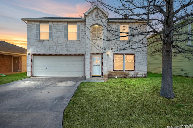 view of front of property featuring a garage and a lawn