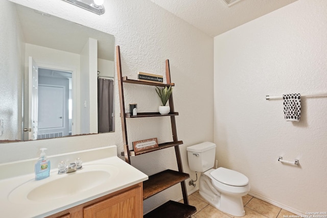 bathroom featuring tile patterned floors, toilet, and vanity