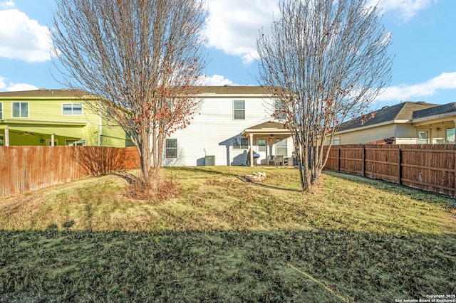 rear view of house featuring a lawn