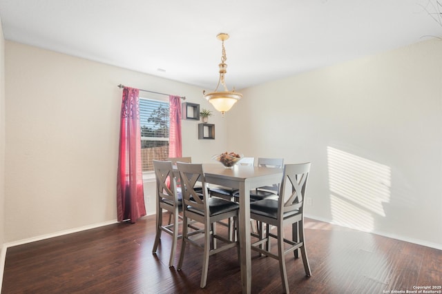 dining area with dark wood-type flooring