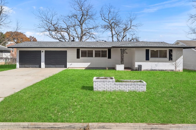 ranch-style home featuring a garage and a front yard