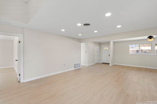 empty room with ceiling fan and light hardwood / wood-style flooring