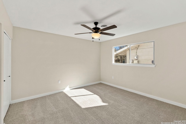 empty room featuring carpet floors and ceiling fan