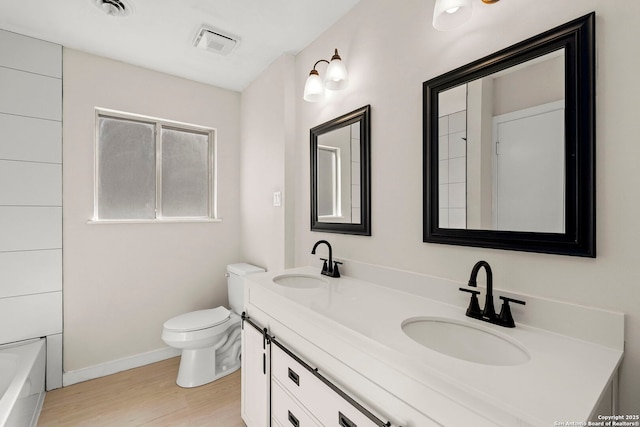 bathroom with vanity, hardwood / wood-style floors, and toilet