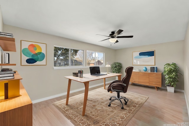 home office featuring light hardwood / wood-style floors and ceiling fan