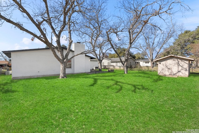 view of yard with cooling unit and a shed