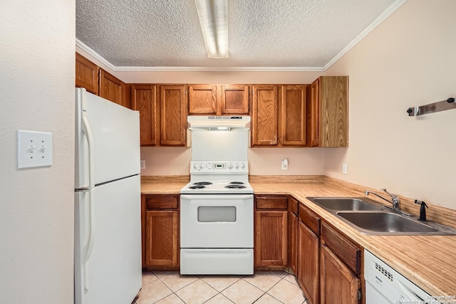 kitchen featuring light tile patterned flooring, under cabinet range hood, white appliances, a sink, and brown cabinets