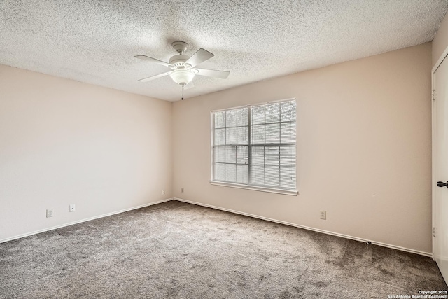 spare room with ceiling fan, carpet floors, a textured ceiling, and baseboards