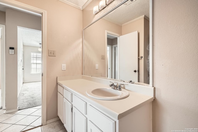 bathroom featuring visible vents, ornamental molding, tile patterned floors, a textured ceiling, and vanity