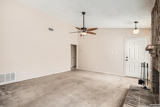 unfurnished living room featuring lofted ceiling, carpet floors, a brick fireplace, and visible vents