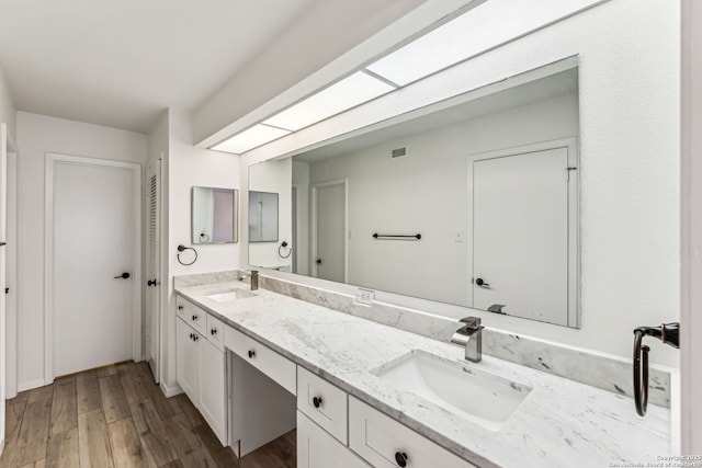 bathroom with vanity and hardwood / wood-style floors