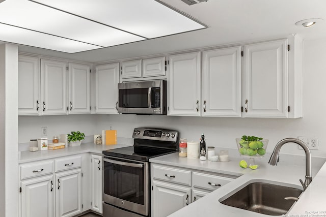 kitchen featuring white cabinetry, stainless steel appliances, and sink