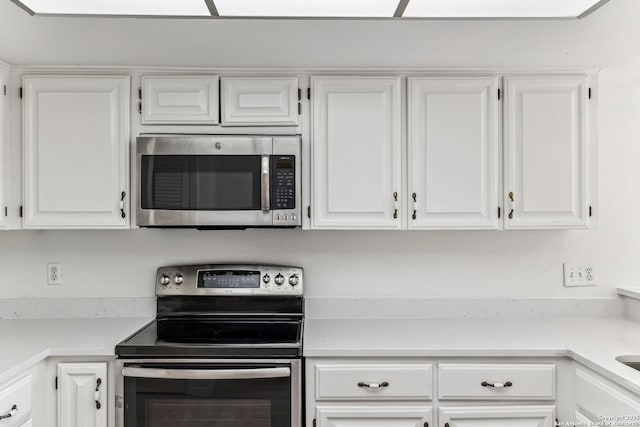 kitchen with white cabinets and appliances with stainless steel finishes