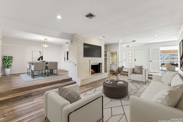 living room featuring a fireplace and light hardwood / wood-style flooring