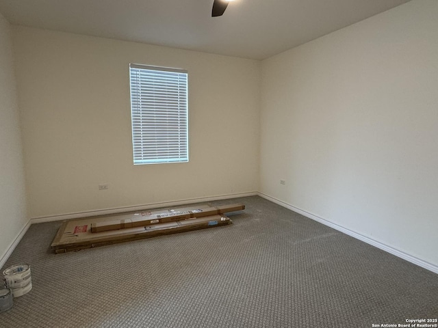 spare room with ceiling fan and carpet