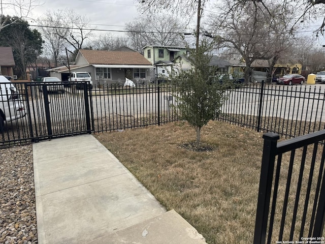 view of gate featuring a lawn