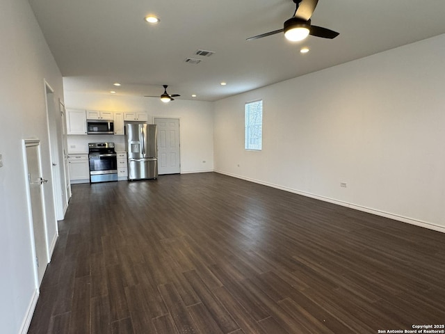 unfurnished living room with dark hardwood / wood-style flooring and ceiling fan