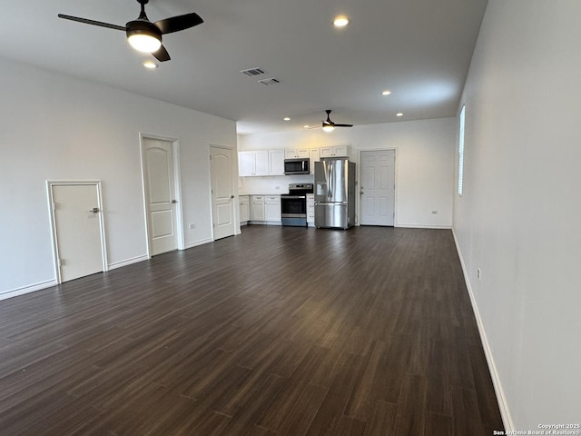 unfurnished living room with dark wood-type flooring and ceiling fan