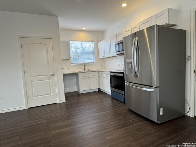 kitchen featuring white cabinetry, sink, dark hardwood / wood-style flooring, and stainless steel appliances