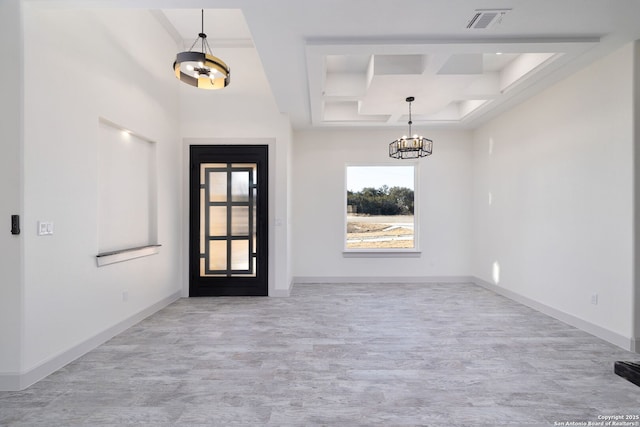 foyer entrance featuring coffered ceiling, a notable chandelier, beam ceiling, and light hardwood / wood-style floors